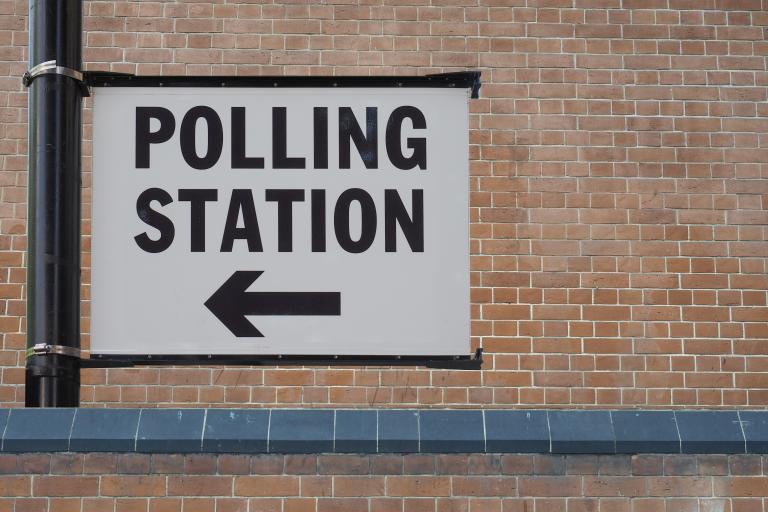 polling station sign on lamppost